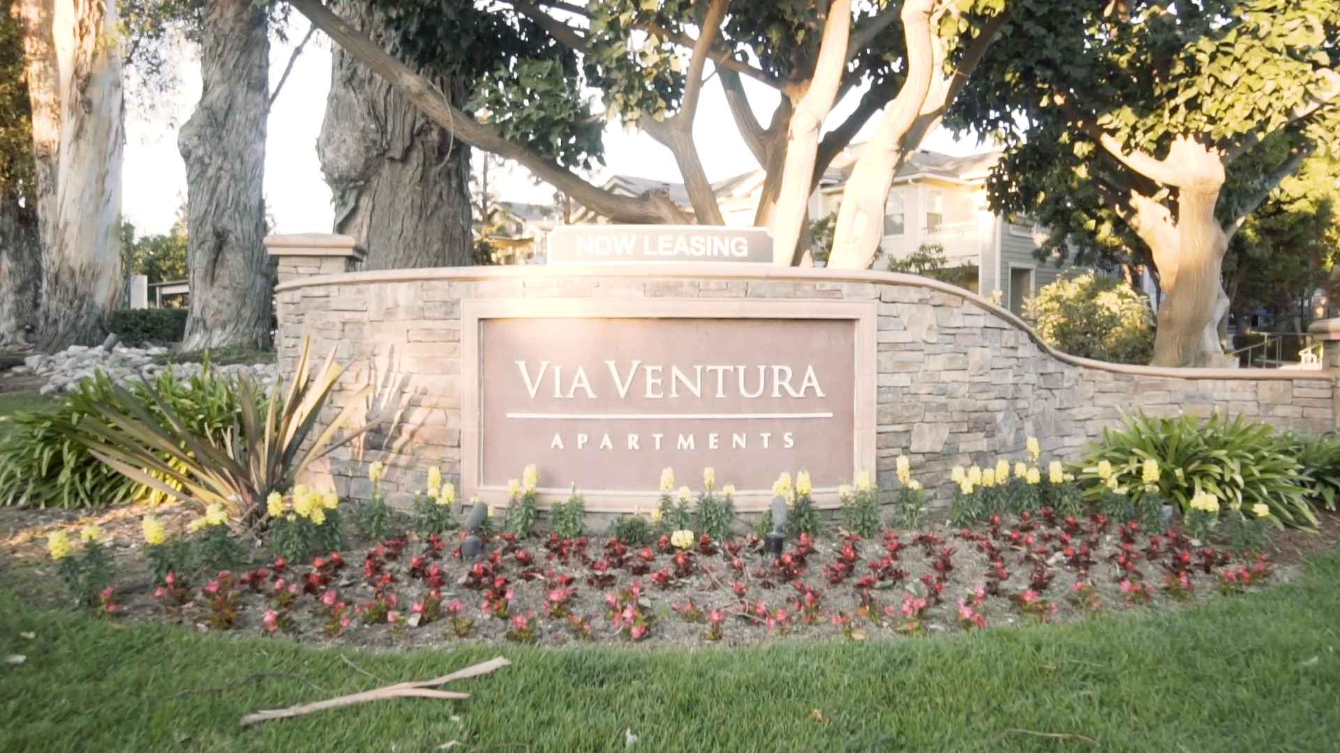 community entrance sign and stone monument at Via Ventura