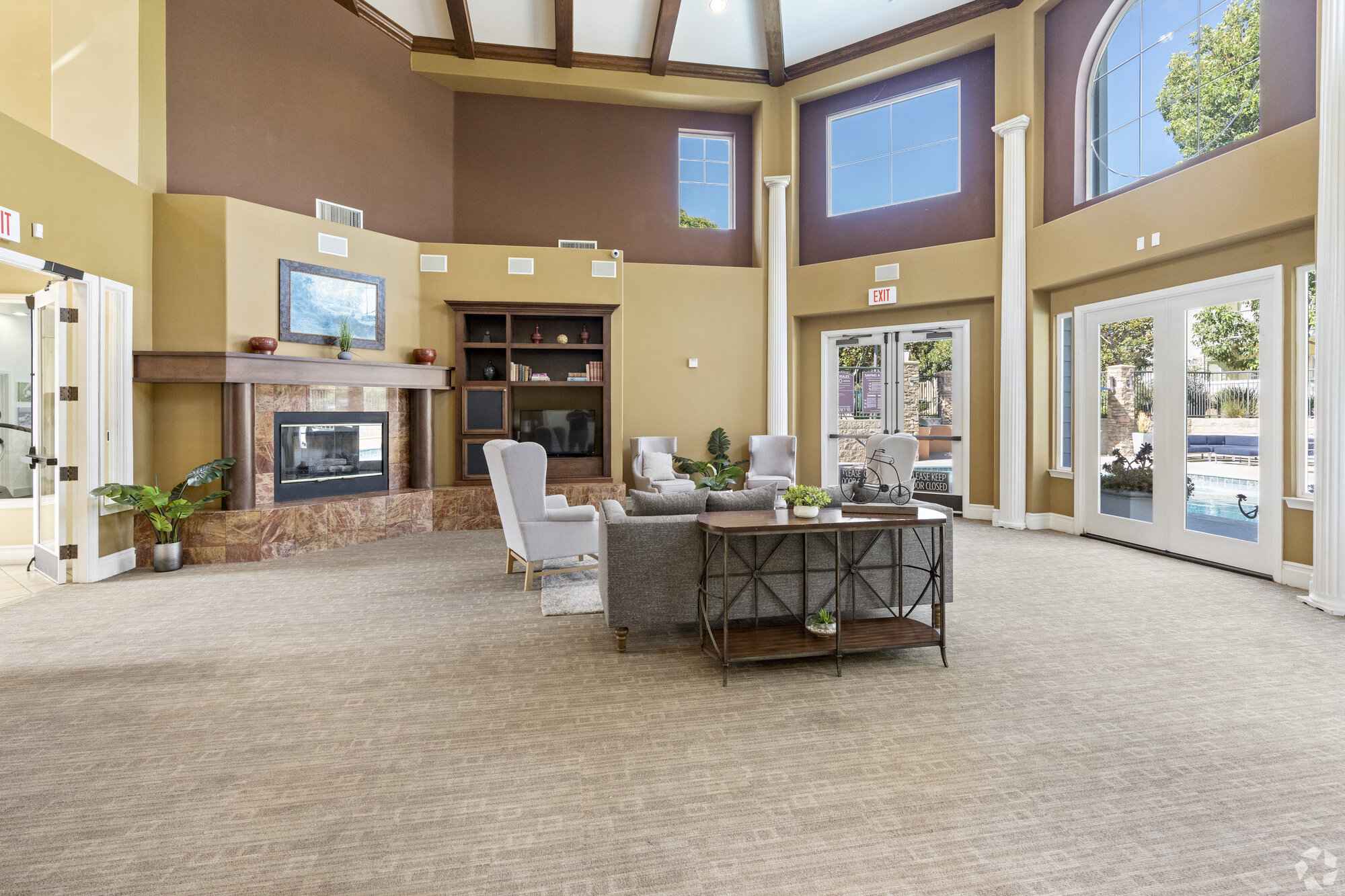 resident clubhouse lounge with fireplace at Via Ventura
