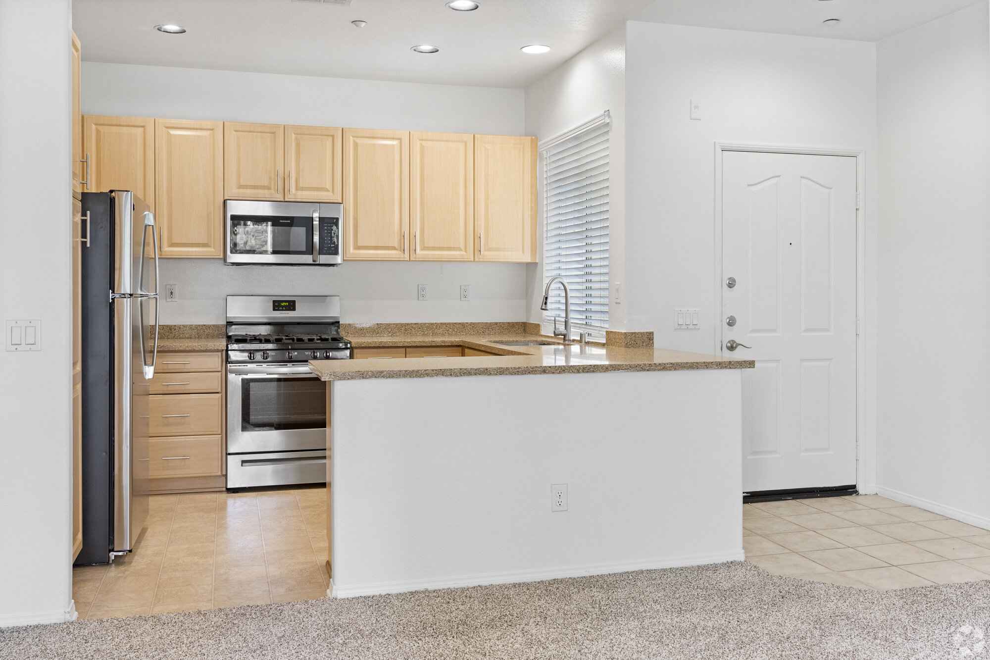 modern kitchen with stainless steel appliances at Via Ventura