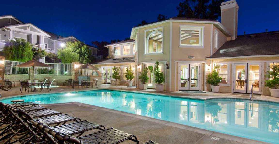 resort style swimming pool at night at Via Ventura
