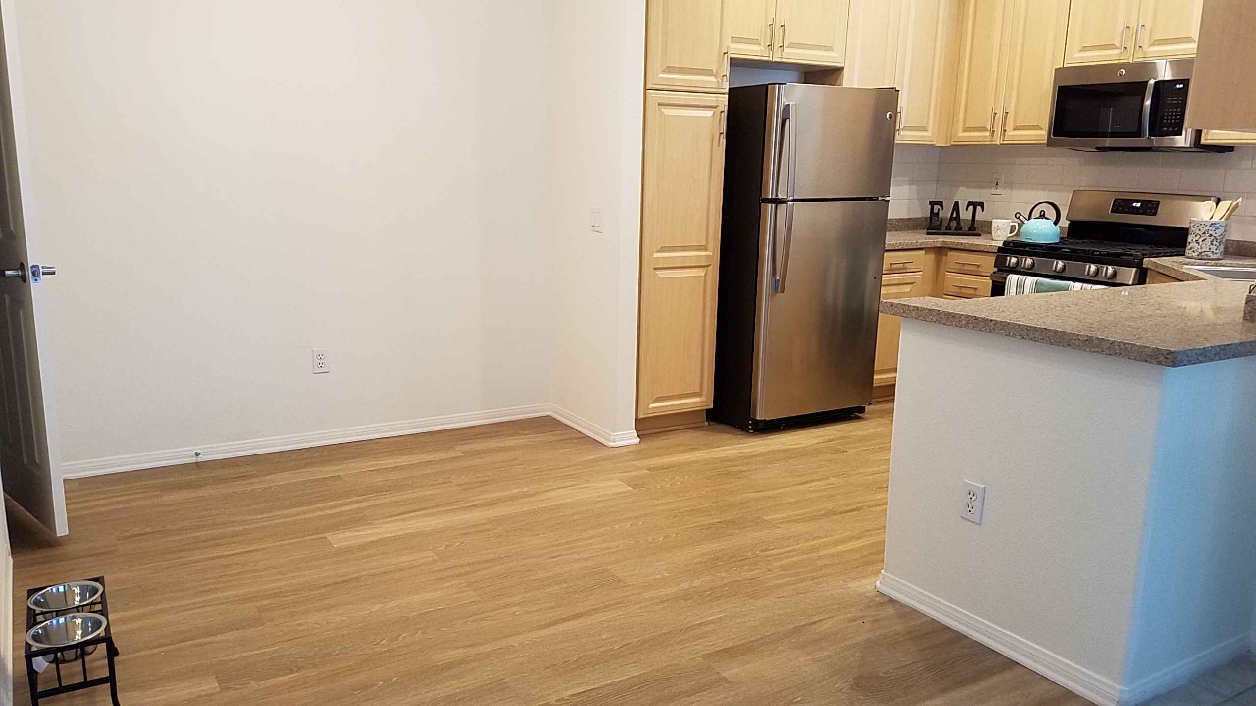 dining area with hardwood style flooring at Via Ventura