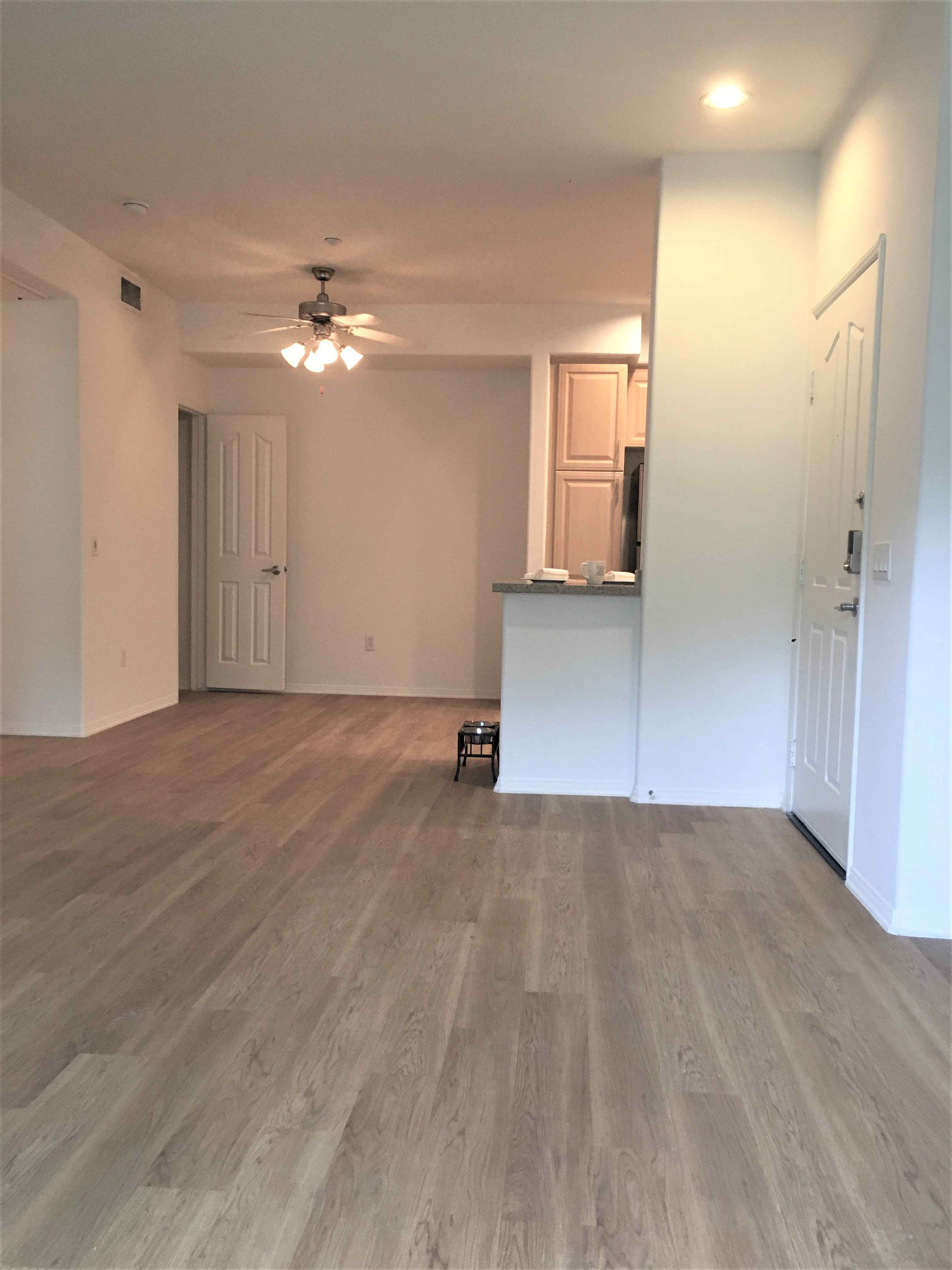 open living area with hardwood style flooring at Via Ventura