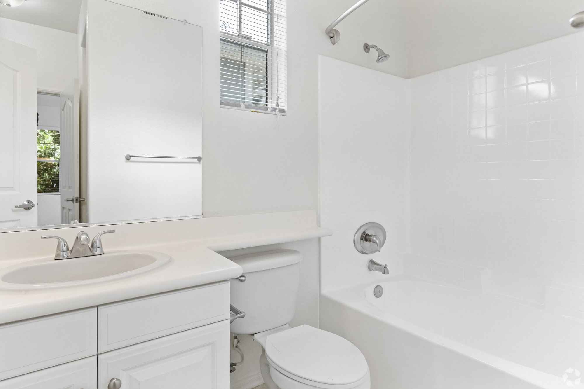 clean bathroom with white vanity and tub shower at Via Ventura