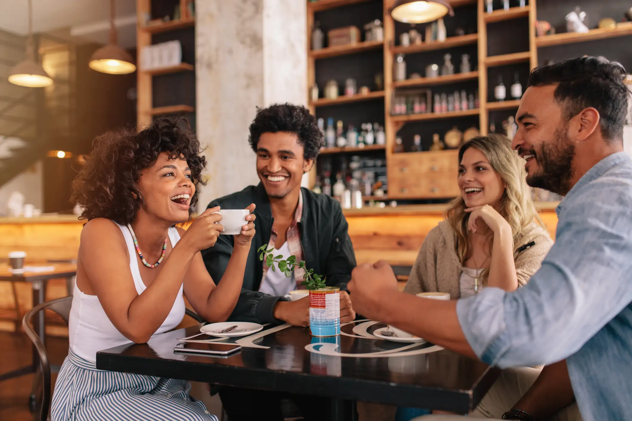 Group of friends at a cafe near Via Ventura Apartments